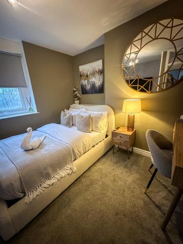 a bedroom with two beds and a mirror at Warm & Cosy, First Floor 2 Bed Central Apartment in Harrogate