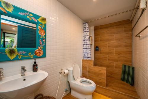 a bathroom with a toilet and a sink at Baan SanSuk Pranburi - Beach Front & Pool Villa in Pran Buri