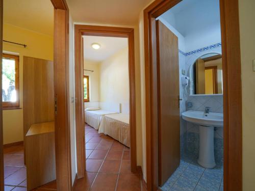 a bathroom with a sink and a toilet and a sink at Residence Villaggio Smedile in Capo Vaticano