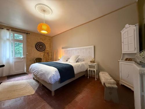 a bedroom with a large bed and a window at Studio Charmant au Château Leugny in La Celle-sous-Gouzon