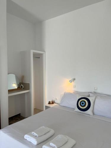 a white bed with two towels on top of it at Vivazoi Ousia studio # 3 in Leipsoi