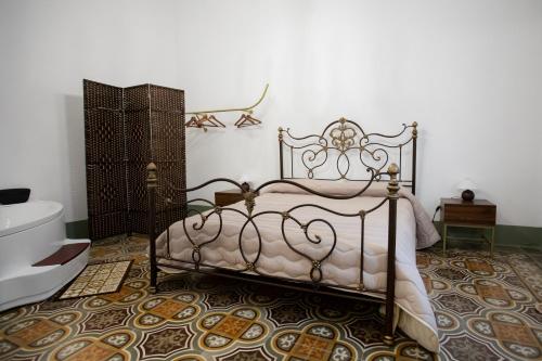 a bedroom with a bed and a bathroom with a tub at Palazzo '800 Cementine in Leverano