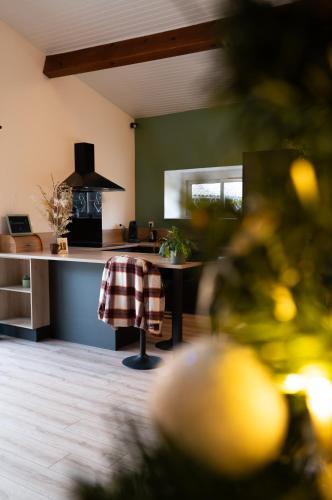 a kitchen with a table and a stove top oven at Burbujas de amor - gîte avec spa et sauna privatifs in Loubès-Bernac
