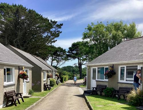 a person walking down a road between houses at Wheal Rodney Holiday Park in Marazion