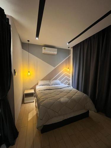 a bedroom with a large bed in a room at Skyhaus Homestay in Penampang