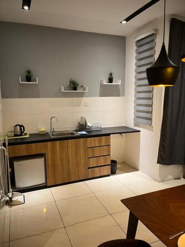 a kitchen with a sink and a counter top at Skyhaus Homestay in Penampang