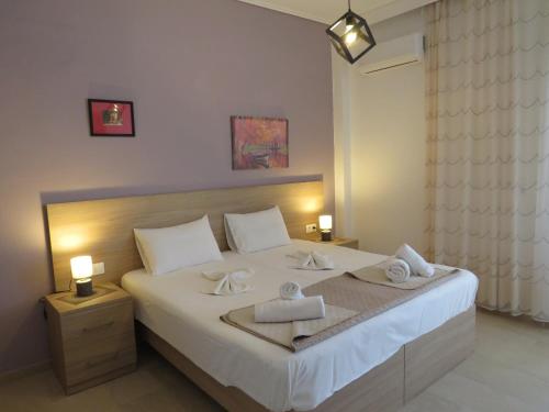 a bedroom with a bed with two towels on it at IASONAS APARTMENTS in Mastihari