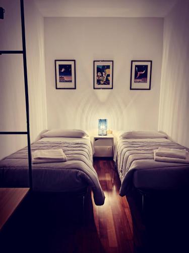 a room with two beds and a night stand at Villa Bazzera in Mestre