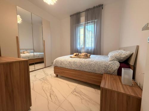 a bedroom with a bed and a large mirror at Il Piano B in Molinella