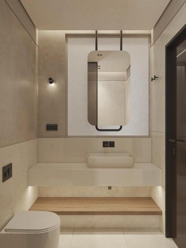 ein Badezimmer mit weißer Toilette und Waschbecken in der Unterkunft Okeanis Elysium in Daratso