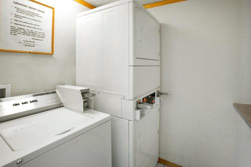 a white refrigerator freezer sitting next to a wall at FairBridge Inn Express Merrillville in Merrillville
