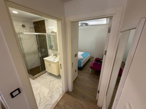 a bathroom with a sink and a mirror at Çeşme Kale Taş Apart in Çeşme