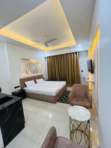 a bedroom with a bed and a couch and a table at Moon Path Stay in Nalmatha