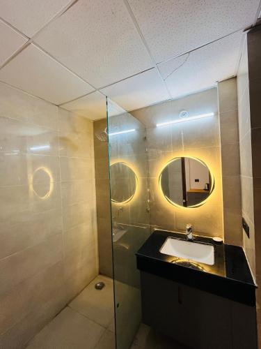 a bathroom with a sink and a mirror at Moon Path Stay in Nalmatha