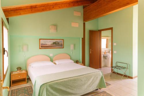 a bedroom with a bed in a green wall at Affittacamere Al Fiume in Flambruzzo
