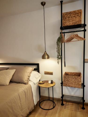 a bedroom with a bed with a table next to it at Ca l'Eli Loft in Montblanc