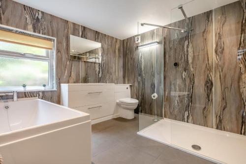 a bathroom with a sink and a toilet and a shower at 2 Bed in Bush oc-s31846 in Bude