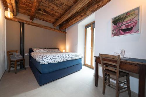 a bedroom with a bed and a table and a desk at Cicapuy in Puys