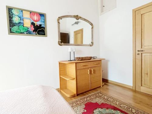 a bedroom with a bed and a mirror on the wall at Tre Terre in Mulazzo