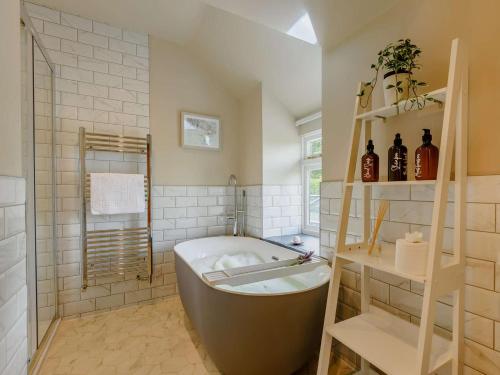 a large bathroom with a tub and a sink at 4 Bed in Oswestry oc-87477 in Llansilin