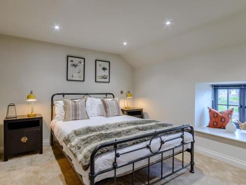 a bedroom with a bed and two windows at 3 Bed in Alnwick oc-77571 in Craster