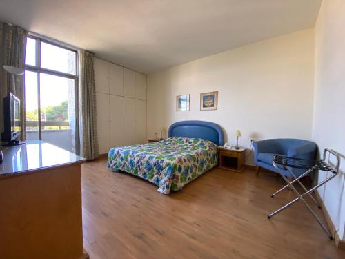 a bedroom with a bed and two chairs and a window at Rabieh Guest house in Rabieh