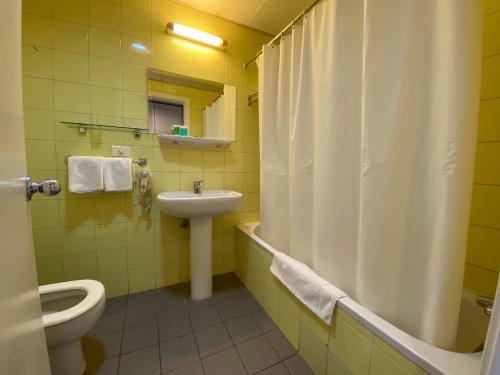 a bathroom with a toilet and a sink and a shower at Rabieh Guest house in Rabieh