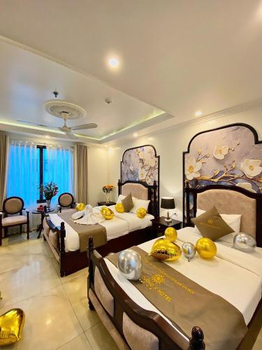a hotel room with two beds with fruit on them at Nam Cường X Hotel in Hanoi