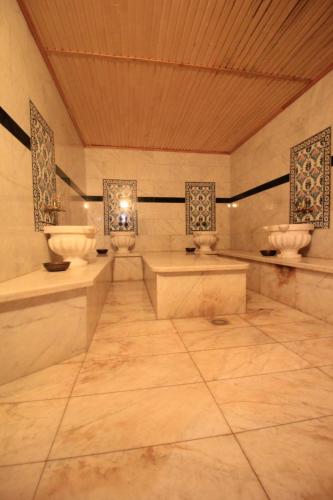 a large bathroom with two sinks and two mirrors at Алма Ата in Borovoye