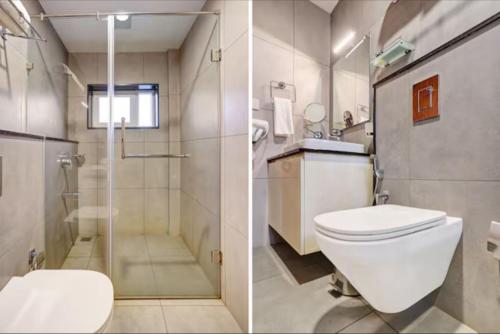 a bathroom with a toilet and a glass shower at Soorya in Attingal
