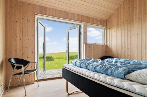 a bedroom with a large bed and a window at 20422-Samso-Egernvej-16 in Ballen