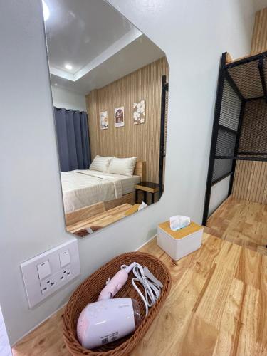 a bedroom with a mirror and a bed in a room at SiLin Hotel in Ban Nong Pling