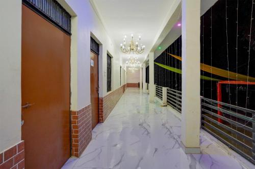 a hallway with a chandelier in a building at SPOT ON Hotel MS Grand in Lucknow