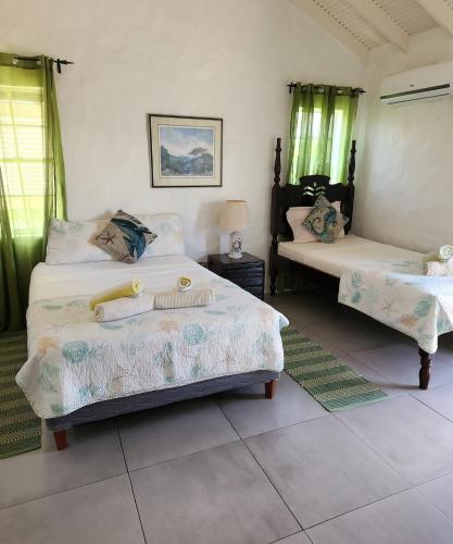 Ліжко або ліжка в номері Two Villas, One Paradise