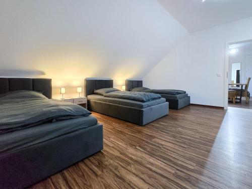 two beds and a couch in a room at Alpha Apartments in Datteln