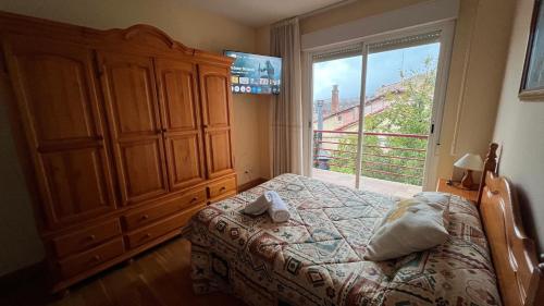a bedroom with a bed and a large window at Casa Alfredo in Badarán