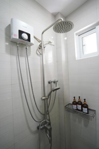 a shower with a shower head in a bathroom at Vine and Canopy in Olongapo