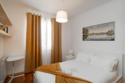a bedroom with a white bed and a window at Sea Side Cozy Matosinhos in Matosinhos