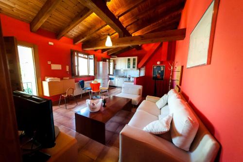 a living room with red walls and a white couch at Villa Don Juan II in Segovia