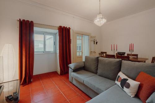 a living room with a couch and a table at Alegria Four - Bedroom House in Porto