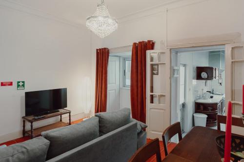 a living room with a couch and a table at Alegria Four - Bedroom House in Porto