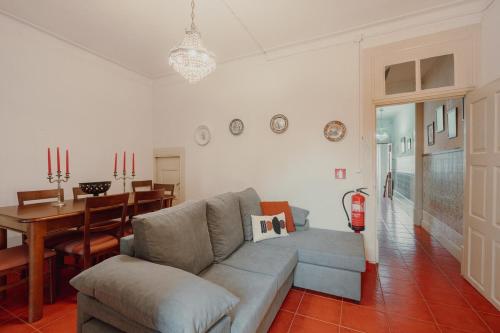 a living room with a couch and a dining room at Alegria Four - Bedroom House in Porto