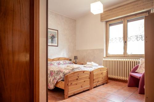 a bedroom with a bed and a window at Hotel Morandi in Valbondione