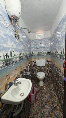 a bathroom with a sink and a toilet in it at Beach Times Resort in Kottakupam