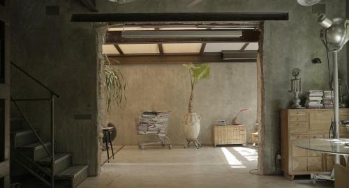 a room with a staircase and a plant in it at Retiro Park Industrial House in Madrid