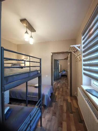 a room with two bunk beds and a hallway at Alejas KAMBARI in Myza Bene