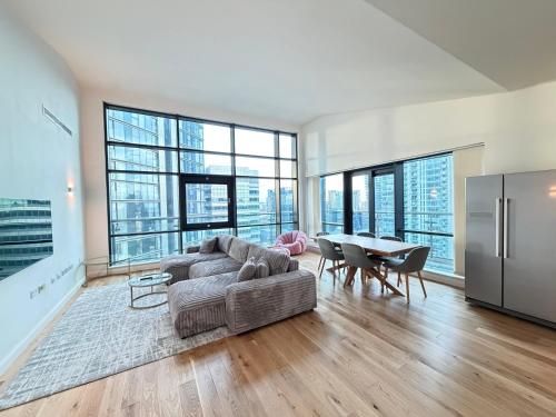 a living room with a couch and a table at Horizon Canary Wharf Apartments in London