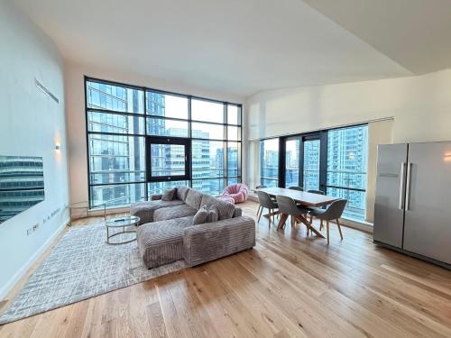 a living room with a couch and a table at Horizon Canary Wharf Apartments in London