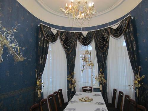 a dining room with a table and a chandelier at Budynok Pyschevycha in Oleksandriya