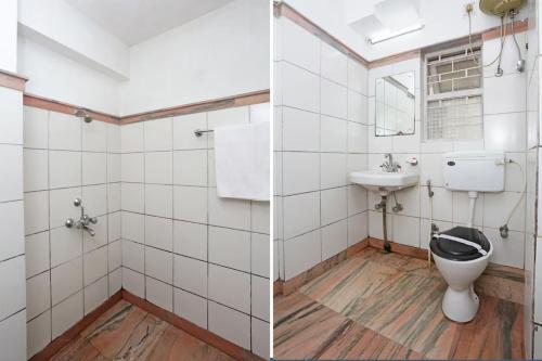 a bathroom with a toilet and a sink at Bengal Inn in Kolkata